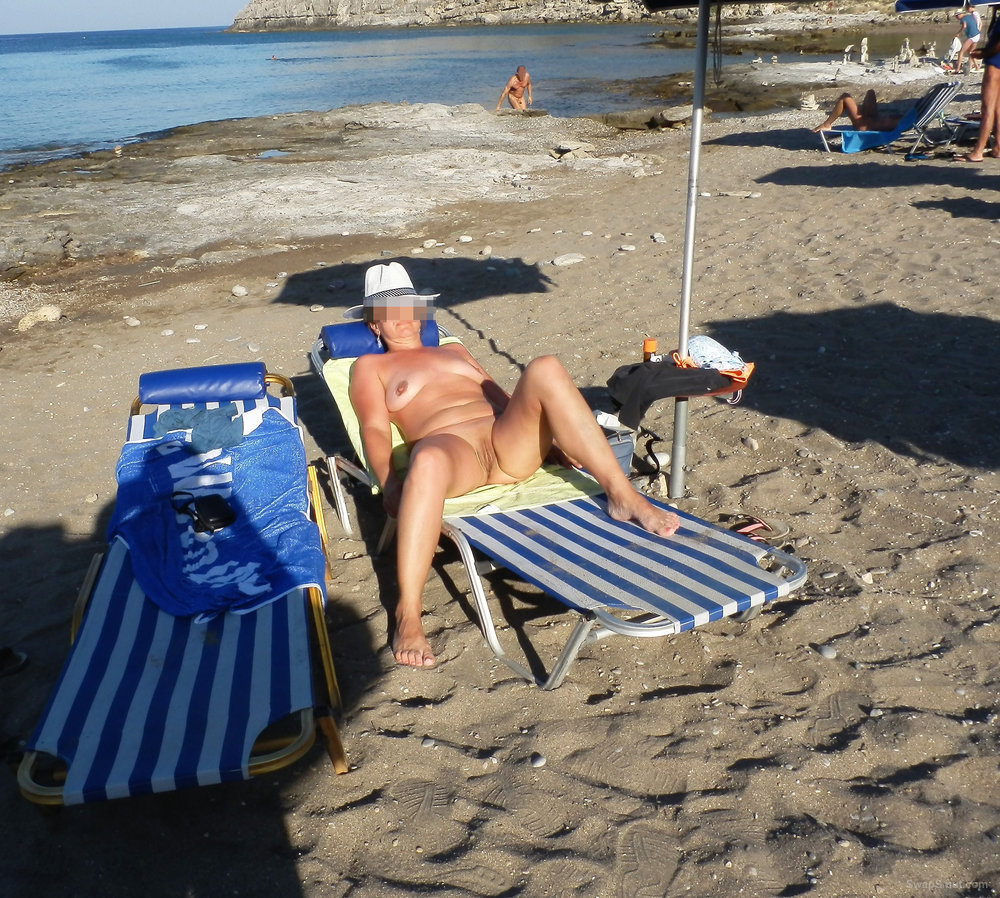 My hot mature wife on a nudist beach photo