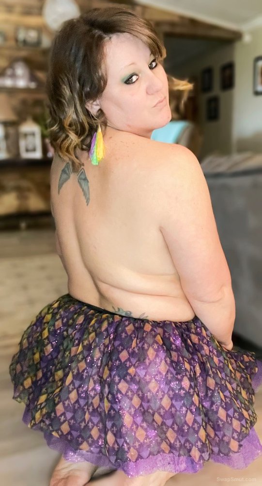 Sexy wife in mardi gras tutu and purple booty shorts