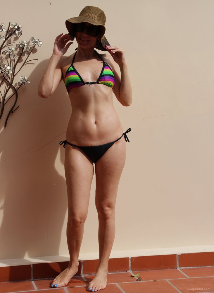 My sexy friend showing off her body in just her bikini and sun hat