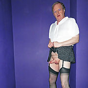 Sissy in short sexy skirt, stockings and suspenders