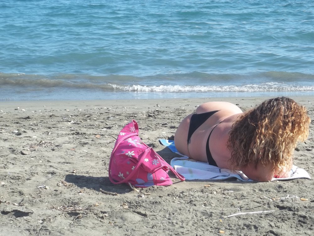 Sexy wife 32 years old milf sunbathing on a public beach