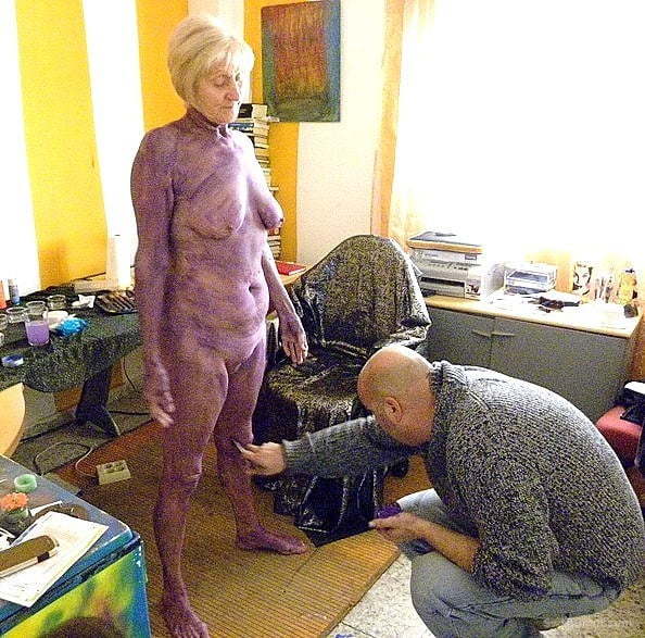 Being body painted and photographed