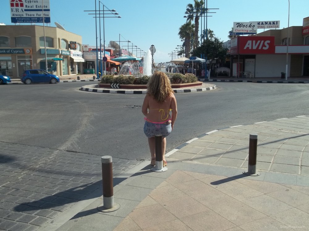 Sexy wife 32 years old walking around by a harbour in a bikini